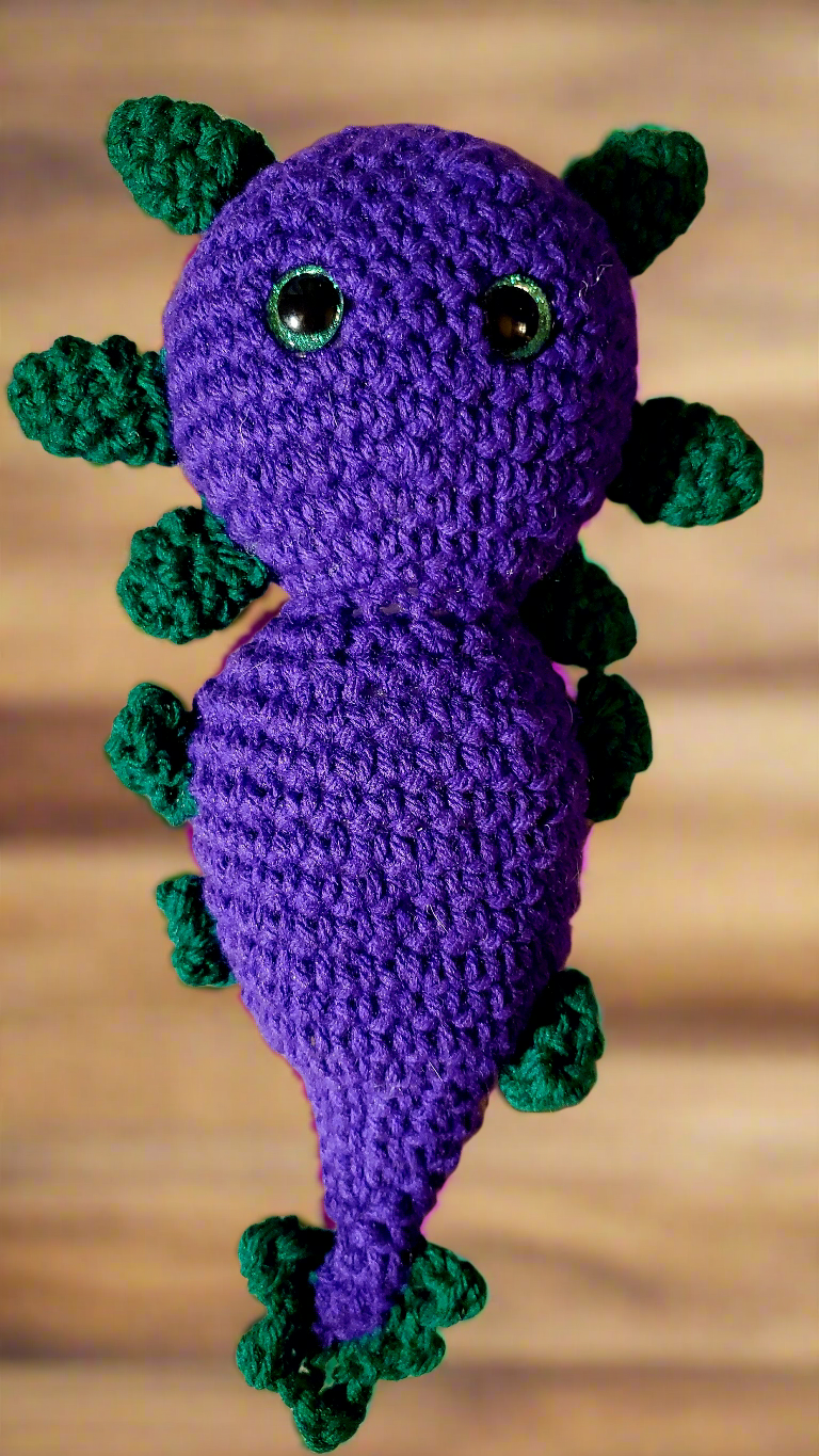 Adorable handmade crocheted stuffed axolotl toy with vibrant colors, perfect for collectors.