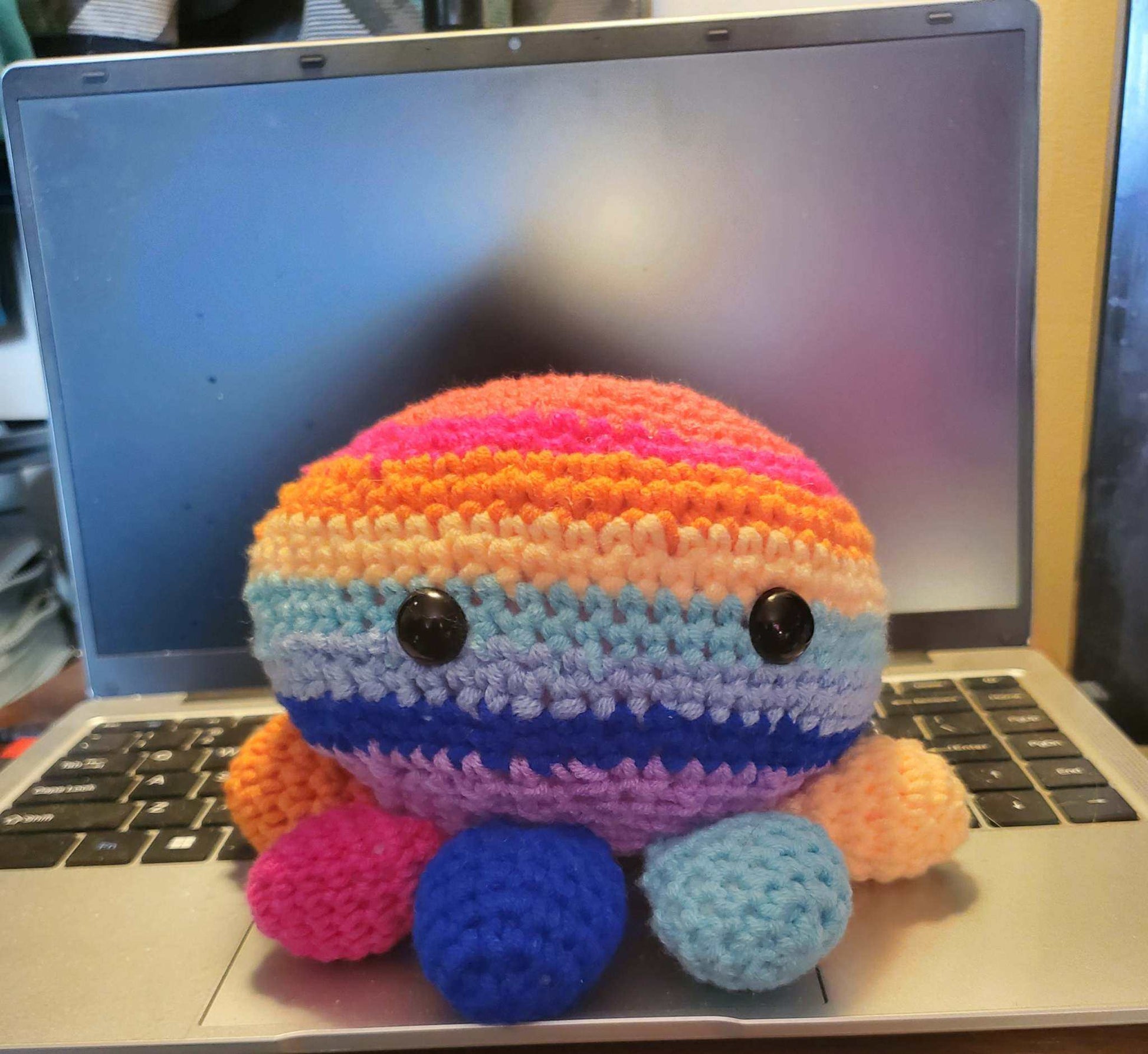 Handmade crocheted rainbow octopus toy with hidden compartment, featuring colorful stripes, safety eyes, and bright tentacles.
