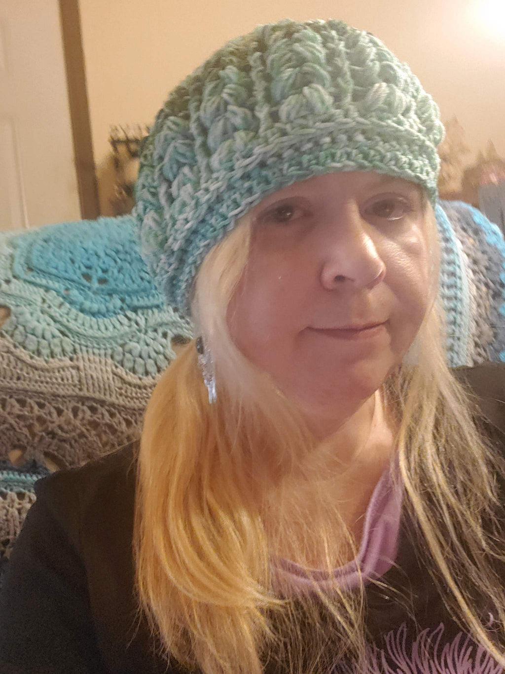 Crocheted Green Ombre Beanie Hat worn by a person, showcasing its stylish and elegant design.
