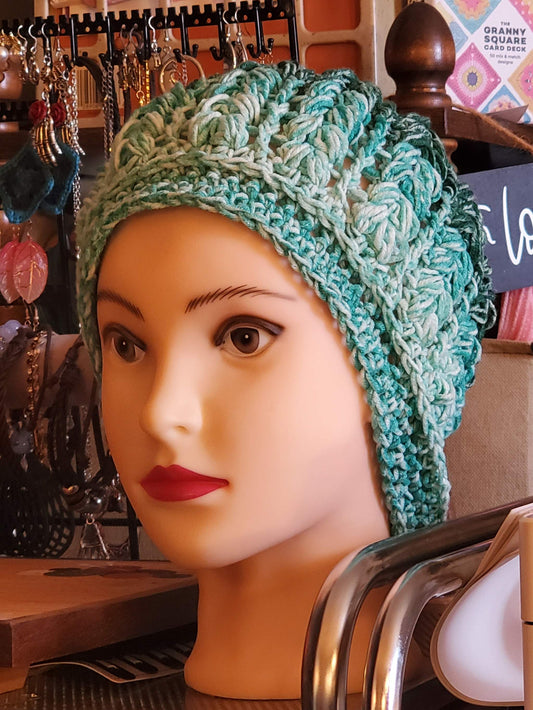 green ombre crochet beanie hat in teal and mint tones with lightweight textured stitch on mannequin head