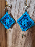 Handmade blue and teal crochet granny square dangle earrings with diamond-shaped motifs and silver-tone hooks