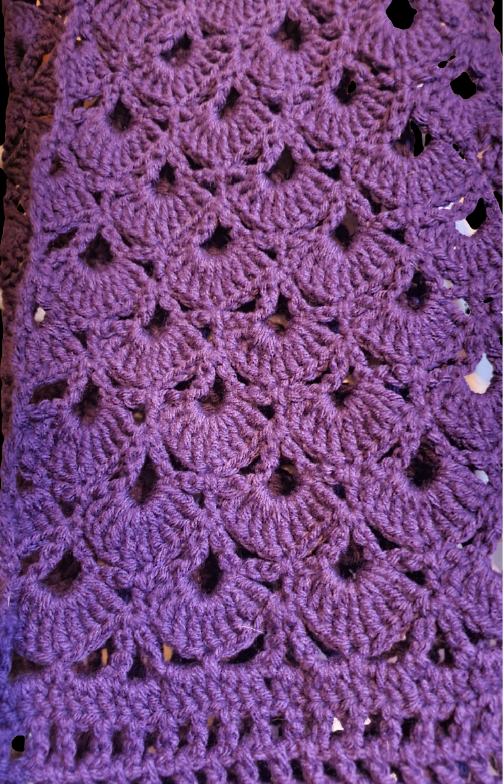 Handmade crochet infinity scarf in deep purple with an intricate lace stitch pattern, oversized and extra long for a dramatic wrap style, shown in close-up detail.