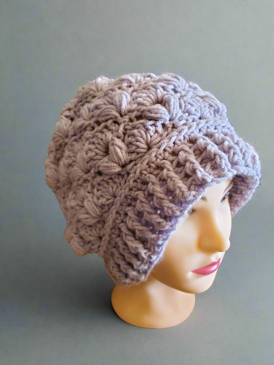 Puff Stitch Slouchy Beanie in textured handmade crochet with ribbed brim on mannequin.