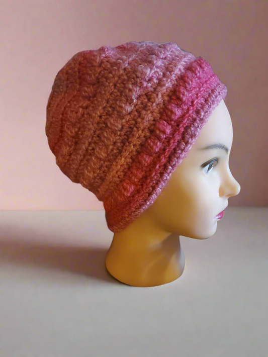 Beautifully crocheted soft pink hat for women and teens, ideal holiday accessory.