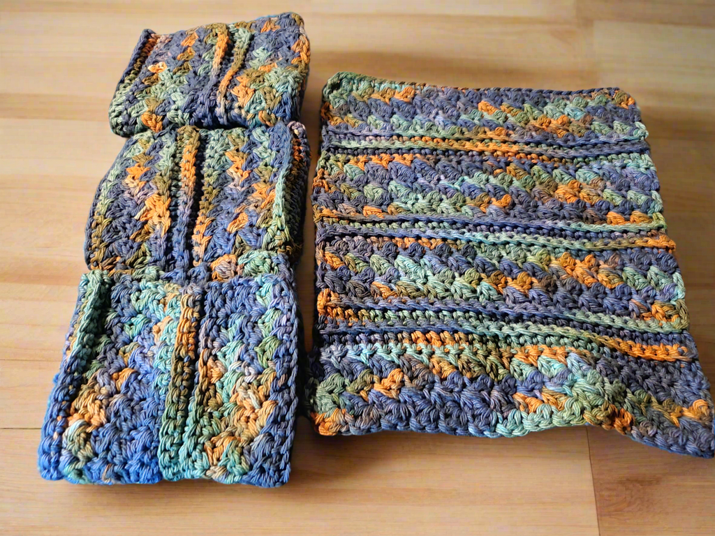 Set of 4 variegated dishcloths in dark blue, green, and brown for kitchen use.