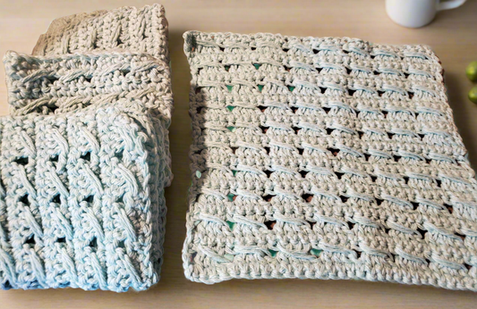Handmade textured aqua dishcloths set of four, ideal for washing dishes.