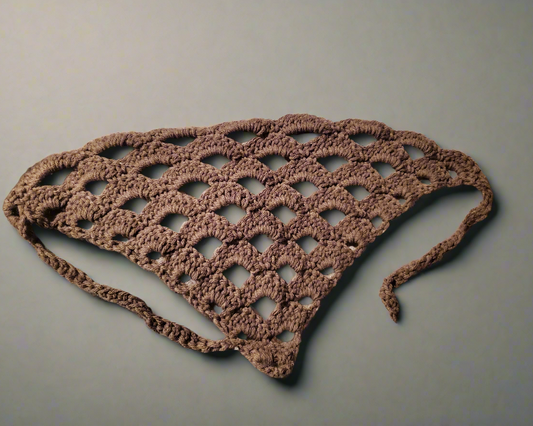 Handmade crochet brown lace hair kerchief with open stitch pattern and tie straps, displayed on a mannequin head.