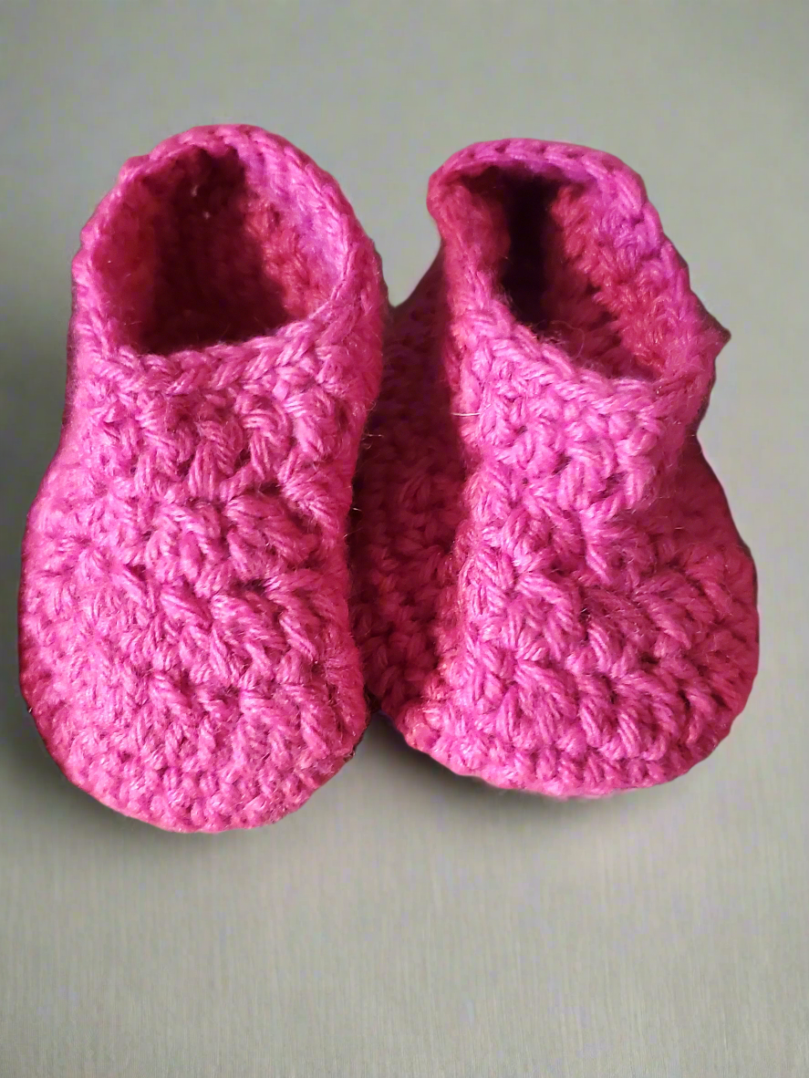 Adorable pink baby hat and booties set, super-soft material, perfect for colder weather.