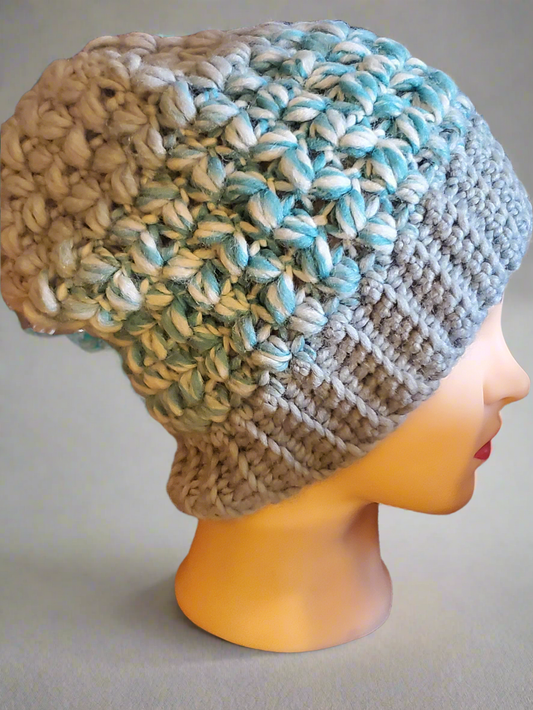 light blue crochet slouchy hat with chunky texture in aqua cream and gray tones on mannequin head