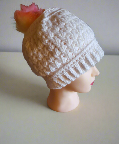 Handmade crocheted white feather stitch hat with rainbow pompom for women.