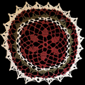 Red, green, and white Christmas doily for festive home decoration.