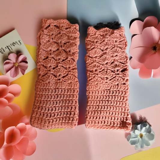 pink crochet fingerless gloves with shell stitch texture laid flat