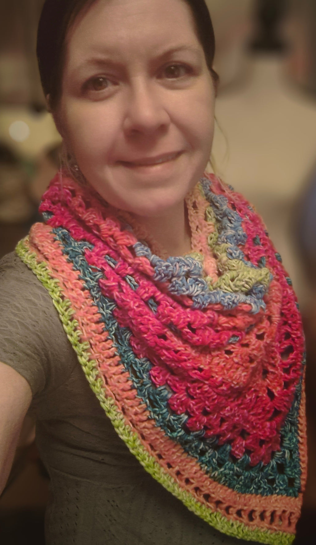 Vibrant Bloom Triangle Shawl handmade crochet scarf in bright pink, peach, teal, blue, and green with textured stitches and lightweight drape