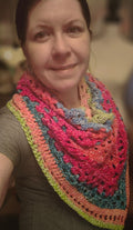 Vibrant Bloom Triangle Shawl handmade crochet scarf in bright pink, peach, teal, blue, and green with textured stitches and lightweight drape