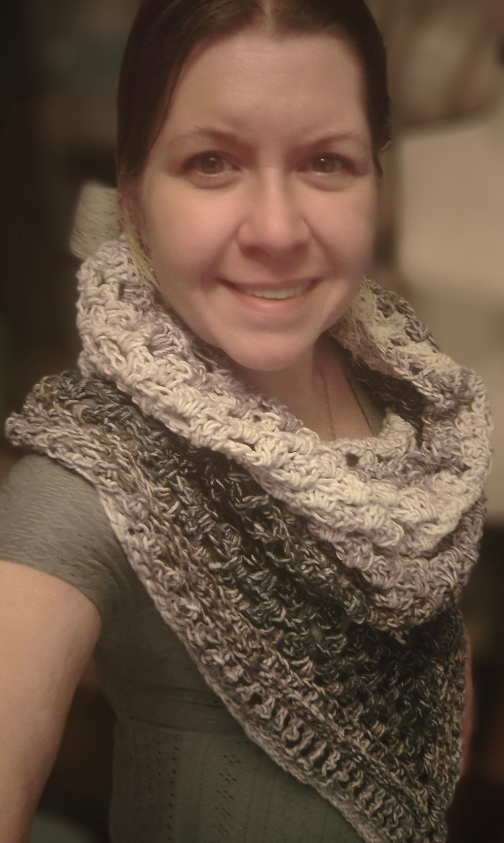 Handmade crochet hooded triangle shawl in neutral tones of cream, taupe, and charcoal, shown worn with the hood up and styled as a cozy wrap.