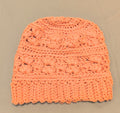 Peach crochet beanie made with cotton blend yarn, lightweight textured handmade hat laid flat on a neutral background
