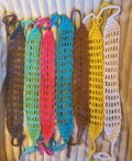Seven handmade openwork crochet tie headbands in gray, green, pink, blue, brown, yellow and white displayed side by side.