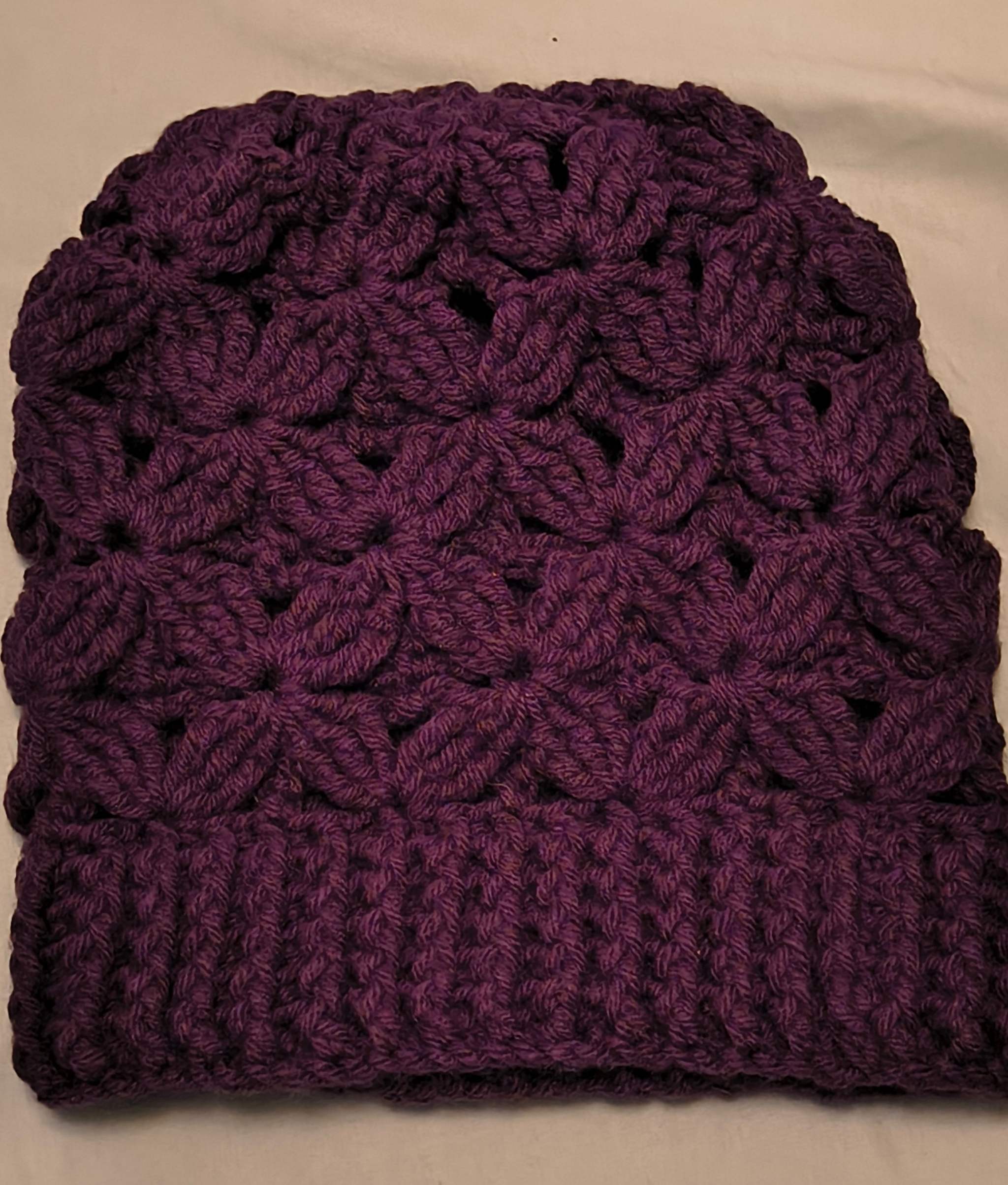 Handmade textured beanie with beautifully crocheted Flower of Life design in purple, rose, and teal colors