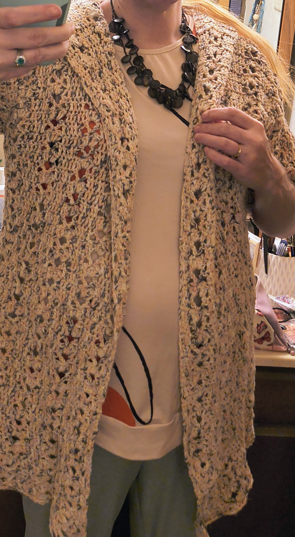 Handmade crochet hooded cardigan in soft neutral speckled cotton yarn, featuring an open front design, textured stitch pattern, and relaxed XL fit